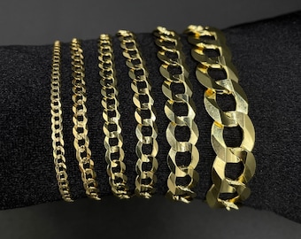 May include: Six gold chain necklaces of varying widths and styles, displayed on a black surface.