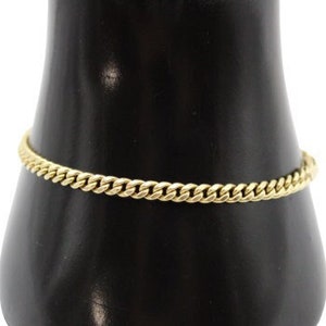 May include: A gold chain bracelet with a curb link design.