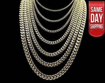 May include: A set of six gold chain necklaces of varying widths, displayed against a black background.
