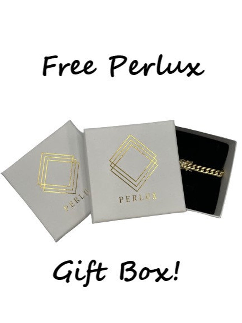 May include: Two white gift boxes with gold foil accents. The boxes have the text "Free Perlux" and "Perlux" printed on them. The boxes are open and show a black velvet box with a gold chain inside. The text "Gift Box!" is printed below the boxes.