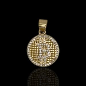 May include: Gold-tone pendant necklace featuring a round charm with a diamond-encrusted Bitcoin symbol.