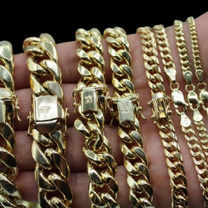May include: A collection of gold chains of varying widths and lengths. The chains are made of 10k gold and feature a classic curb link design.