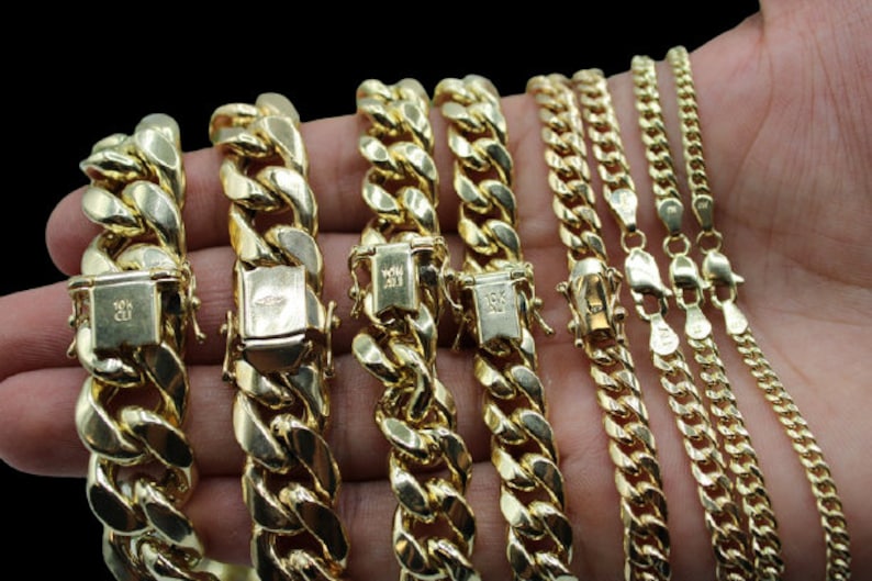 May include: A collection of gold chains of varying widths and lengths. The chains are made of 10k gold and feature a classic curb link design.