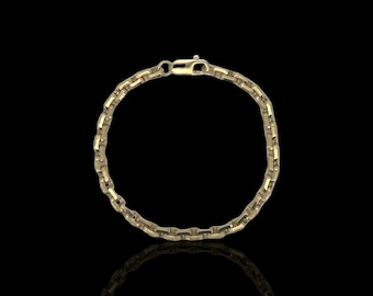 May include: A gold chain bracelet with a box chain design. The bracelet is made of 14k gold and has a polished finish.
