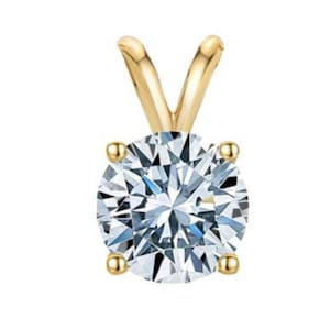 May include: A gold pendant featuring a round, clear, faceted gemstone.