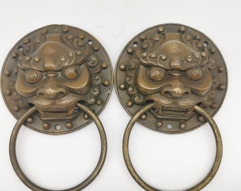 A pair of Chinese antique hand-carved brass lion head door knockers, worth collecting