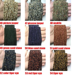 May include: Assortment of 10 strands of gemstone beads, including picture jasper, picasso jasper, unakite, green sand stone, blue sand stone, gold sand stone, color tiger eye, red tiger eye, and tiger eye.