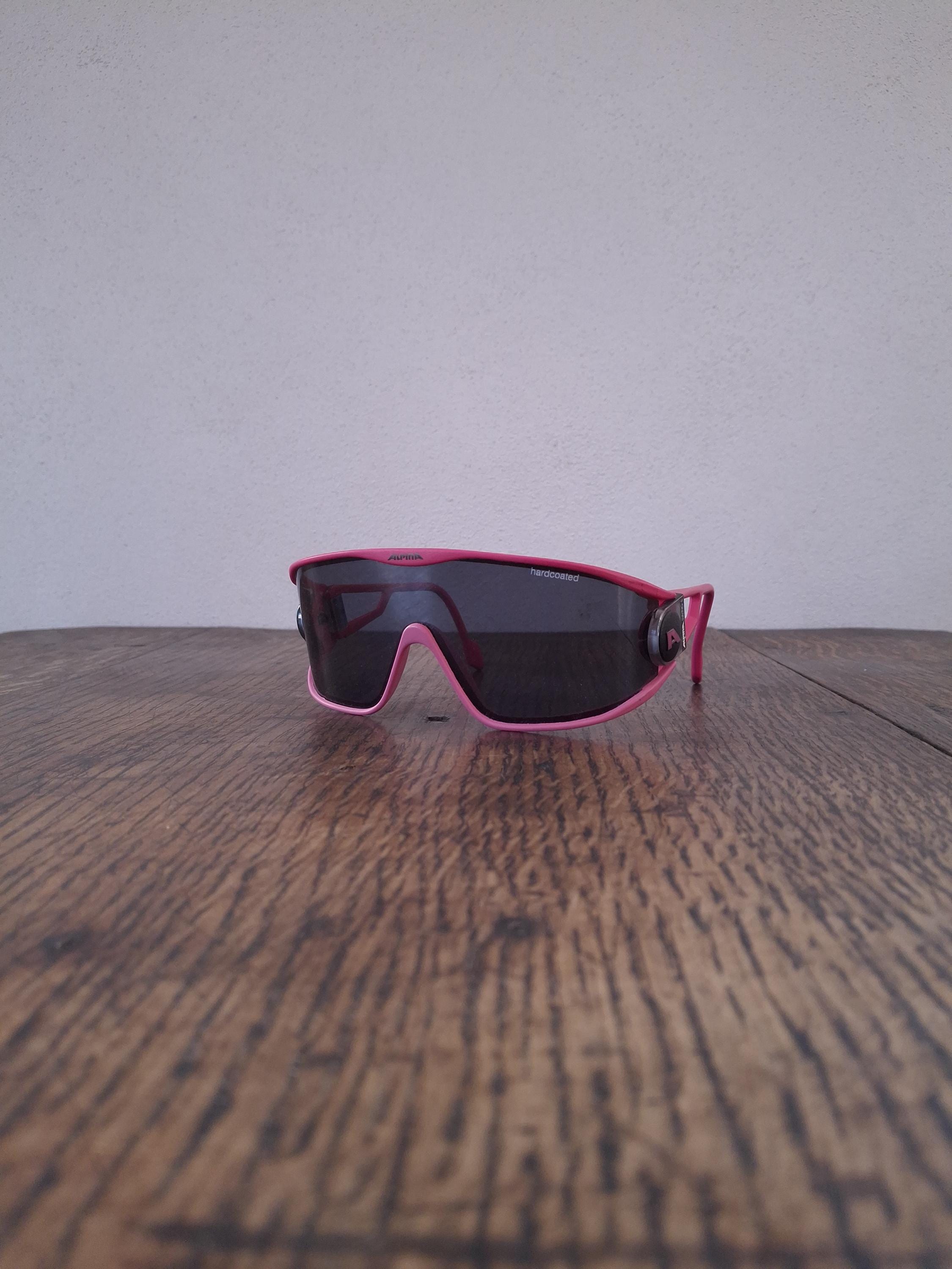 Vintage 90's German oversized wide pink Alpina cycling sunglasses with adjustable temple arms and gray lenses.