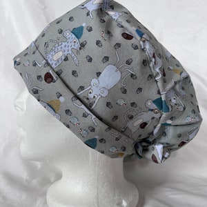 May include: A gray scrub hat with a white tie. The hat has a pattern of mice and acorns.