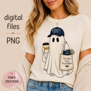 May include: A cream-colored t-shirt featuring a graphic of a white ghost wearing a navy blue baseball cap with the text "gilmore girls". The ghost holds a coffee cup labeled "Lukes" and a tote bag with a book and the text "I'd rather be in Stars Hollow".