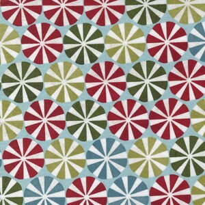 May include: A repeating pattern of colorful circles with a radiating design. The circles are red, white, green, and blue on a light blue background.