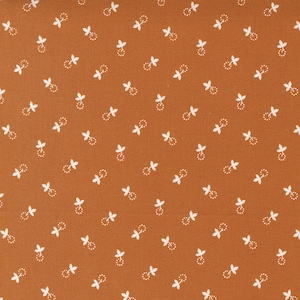 May include: A brown fabric with a white repeating pattern of small leaves. The fabric has a subtle texture.