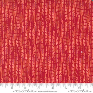 May include: Red fabric with a repeating pattern of thin, light orange lines on a dark red background. The fabric is measured with a ruler in inches.