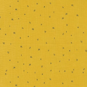 May include: A yellow fabric background with a scattered pattern of black lines and shapes.