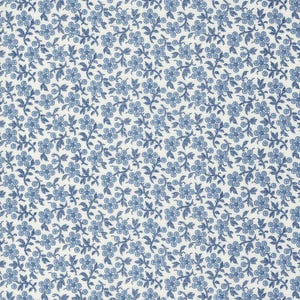 May include: A close-up of a white fabric with a repeating pattern of blue floral designs. The flowers are small and detailed, with a dotted texture. The leaves and stems are also blue, creating a cohesive and delicate pattern.