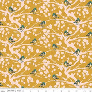 May include: A yellow fabric with a repeating pattern of white branches, pink leaves, and blue and yellow birds.