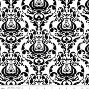 May include: Black and white damask fabric with a repeating pattern of a stylized lyre.