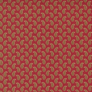 May include: Red fabric with a repeating pattern of brown paisley shapes.