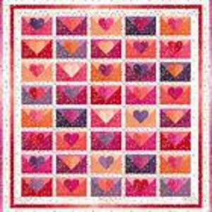 May include: A quilted blanket featuring a repeating pattern of colorful envelope designs, each with a heart in the center. The envelopes are in shades of pink, red, and orange, set against a white background with a dotted pattern and a red border.