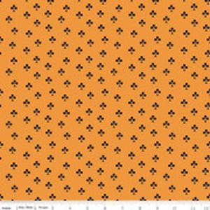 May include: A seamless orange fabric with a repeating pattern of black clover symbols.