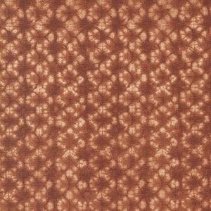 May include: Close-up of a fabric with a repeating pattern. The design features a diamond grid with floral-like shapes in a lighter shade of brown against a darker brown background. The fabric has a textured appearance.