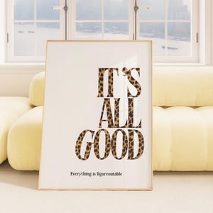 Könnte beinhalten: Ein gerahmter Kunstdruck mit dem Text "IT'S ALL GOOD" in einer kräftigen Leopardenmuster-Schriftart. Darunter steht der Satz "Everything is figureoutable" in einer kleineren, einfachen Schriftart. Das Kunstwerk wird vor einem weißen Hintergrund präsentiert.