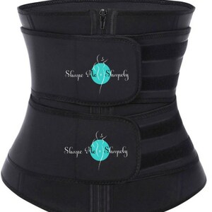 May include: Black waist trainer with adjustable straps and a zipper closure. The waist trainer has the text "Shape Me Shapely" printed on it.
