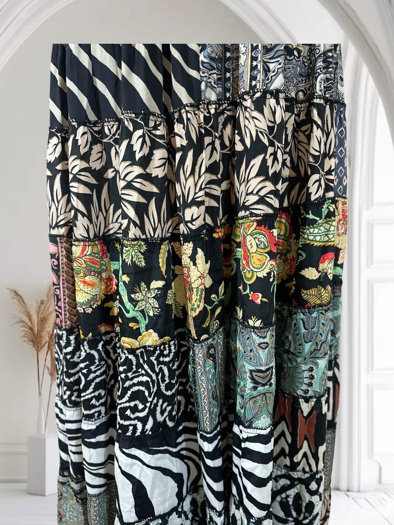 May include: A patchwork skirt with a variety of patterns, including floral, zebra stripes, and geometric designs. The skirt features a mix of black, white, and colorful fabrics, creating a bohemian style. The skirt is long and flowing, suitable for a casual or dressy occasion.