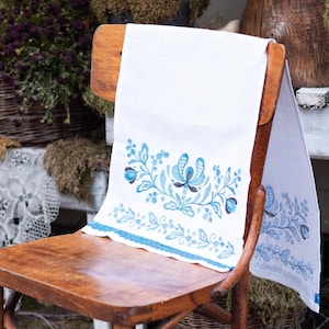 White linen towel with blue floral embroidery