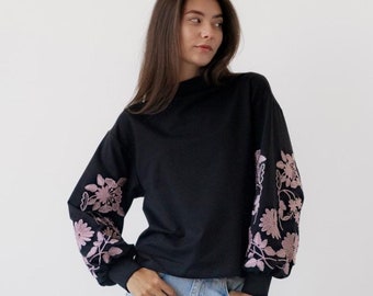 Black sweatshirt with pink floral embroidered sleeves, Stylish oversized pullover, Cozy long sleeve top for casual wear or layering