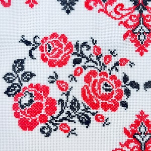 Handmade embroidered towel with red rose motifs and lace trim