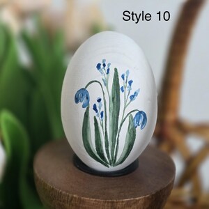 May include: A set of three ceramic mugs with a speckled, matte finish. The mugs are in shades of cream, light gray, and dark gray. Each mug has a simple, minimalist design and a rounded handle. The mugs are suitable for coffee, tea, or other beverages.