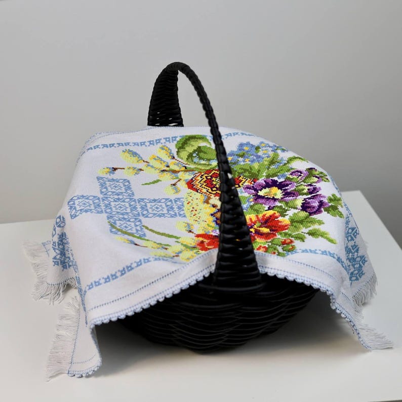 Easter basket cover with blue cross embroidery and spring floral design