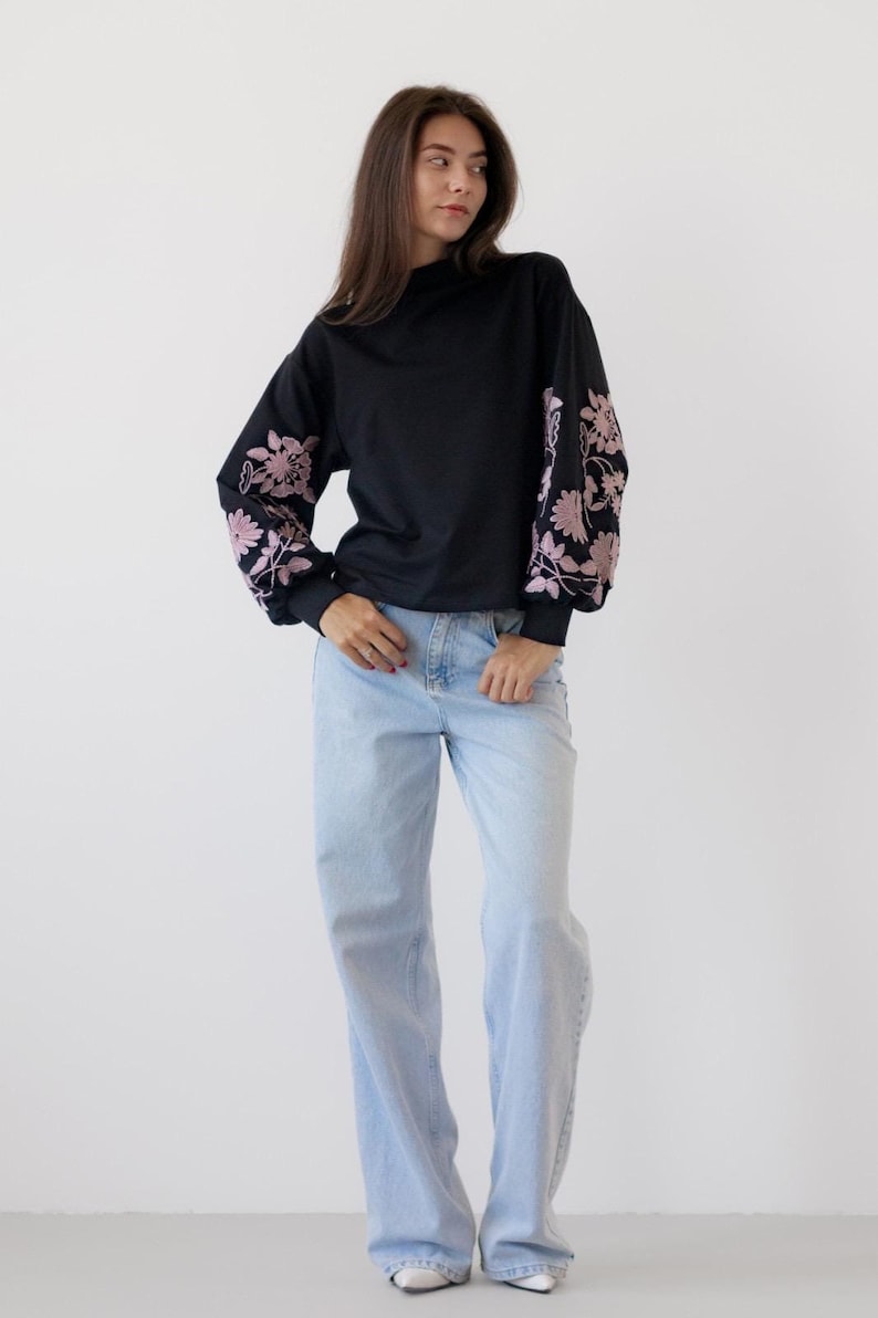 Black sweatshirt with pink floral embroidered sleeves