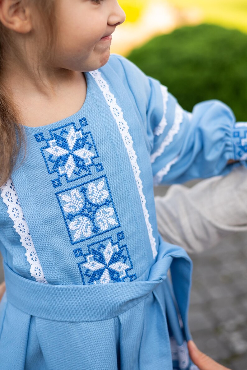 Traditional blue embroidered Ukrainian girl dress with long sleeves and white lace trim, Folk style cotton outfit for special occasions