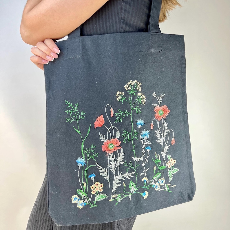 Black canvas tote with embroidered wildflowers, poppies and cornflowers, reusable cotton shoulder bag for shopping, books, market and gifts