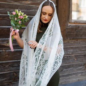 Elegant white lace shawl with fringe