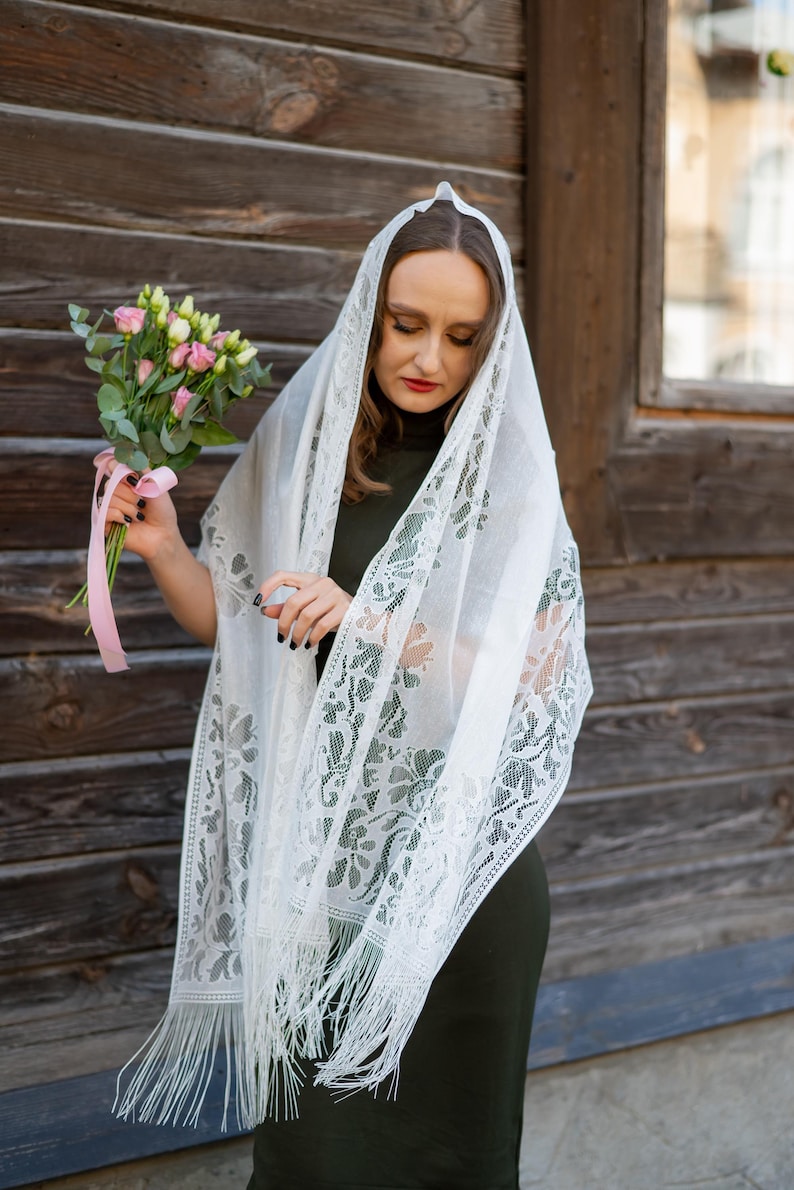 Elegant white lace shawl with fringe