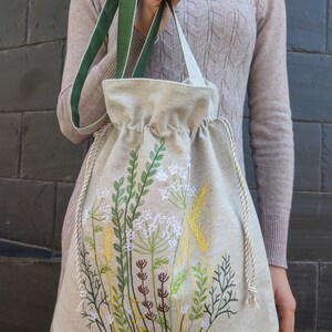 Handwoven blue drawstring bag with geometric embroidery, Boho crossbody bag, Ethnic-inspired backpack with adjustable straps image 8