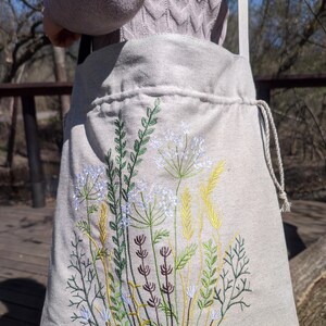 Handwoven blue drawstring bag with geometric embroidery, Boho crossbody bag, Ethnic-inspired backpack with adjustable straps image 9