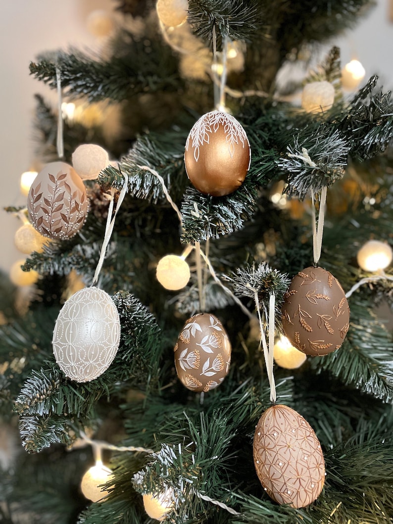Decorative hand painted egg ornaments with botanical patterns, Symbolic hanging accents for neutral home styling and seasonal interior decor