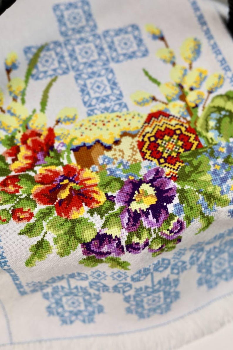 Easter basket cover with blue cross embroidery and spring floral design