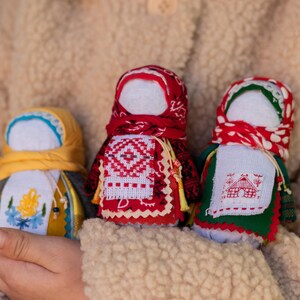 Traditional cloth doll in yellow with floral embroidery