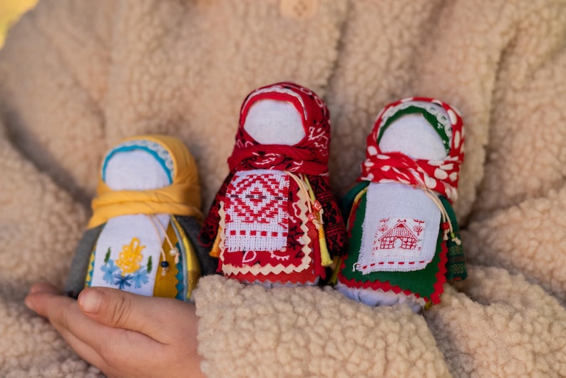 Traditional cloth doll in yellow with floral embroidery