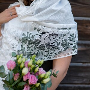 Elegant white lace shawl with fringe