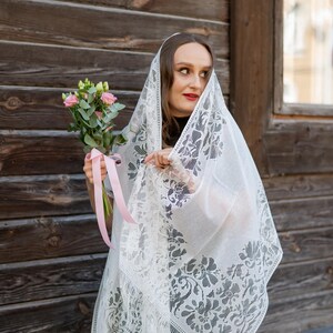 Elegant white lace shawl with fringe