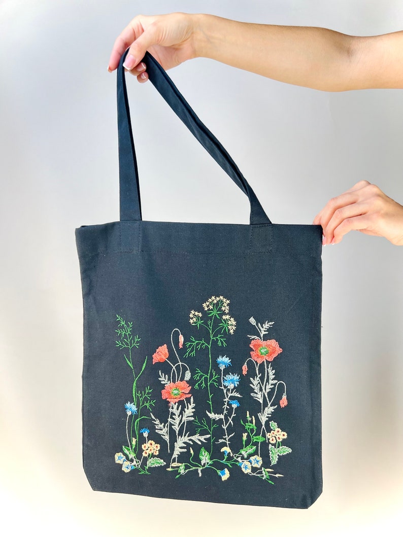 Black canvas tote with embroidered wildflowers, poppies and cornflowers, reusable cotton shoulder bag for shopping, books, market and gifts