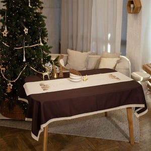 Christmas table runner with embroidered gingerbread house design
