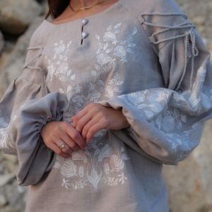 gray linen blouse with puffy sleeves and intricate white embroidery