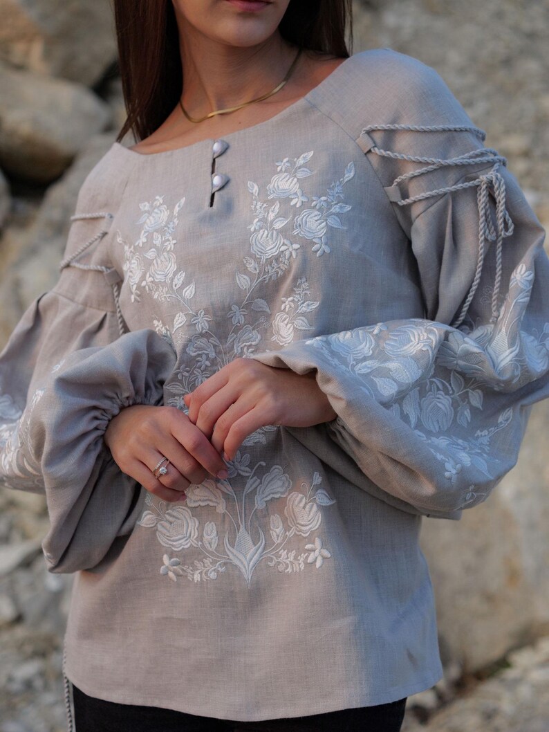 gray linen blouse with puffy sleeves and intricate white embroidery